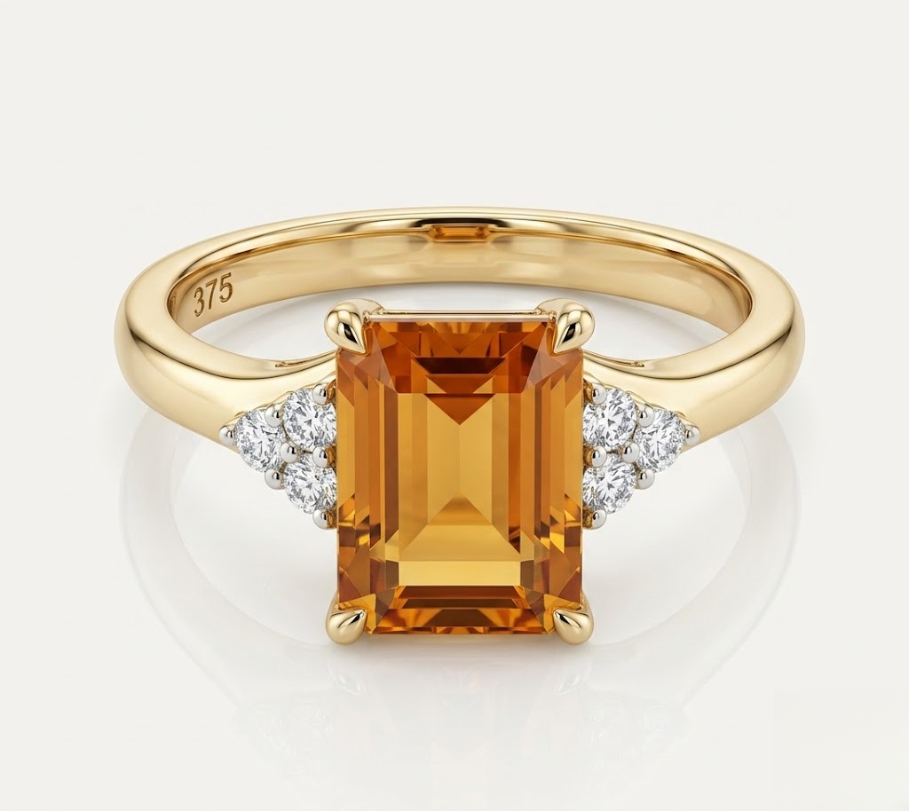 A yellow gold ring featuring a large rectangular emerald-cut orange citrine center stone, accented by small round-cut diamonds on either side of the band. The inside of the band is stamped with '375'.